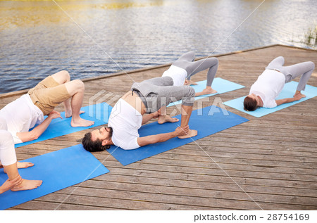 group of people making yoga exercises outdoors group of people making yoga exercises outdoors 28754169