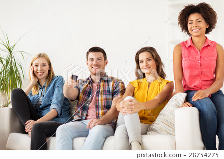 happy friends with remote watching tv at home 28754275