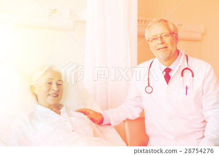 doctor visiting senior woman at hospital ward 28754276