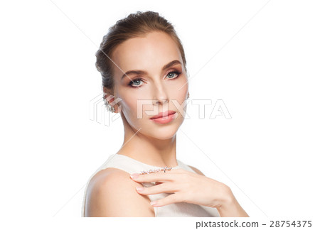 smiling woman in white dress with diamond jewelry 28754375