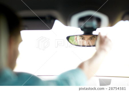 man driving car adjusting rearview mirror man driving car adjusting rearview mirror 28754381