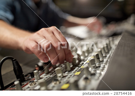 man using mixing console in music recording studio man using mixing console in music recording studio 28754416