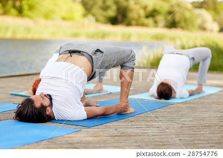 group of people making yoga exercises outdoors 28754776
