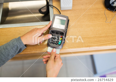 close up of hand inserting bank card to terminal 28754829