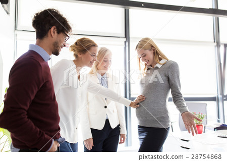 happy colleagues with pregnant woman at office happy colleagues with pregnant woman at office 28754868