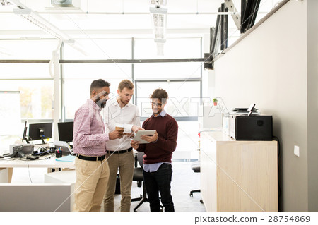 business team with tablet pc and coffee at office business team with tablet pc and coffee at office 28754869