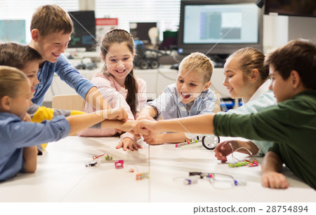 happy children making fist bump at robotics school 28754894