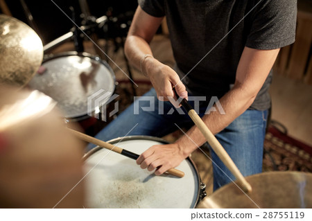 male musician playing drums and cymbals at concert 28755119