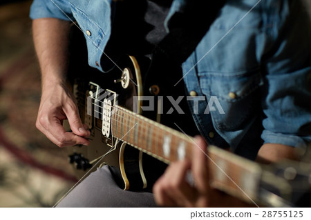 close up of man playing guitar at studio rehearsal close up of man playing guitar at studio rehearsal 28755125
