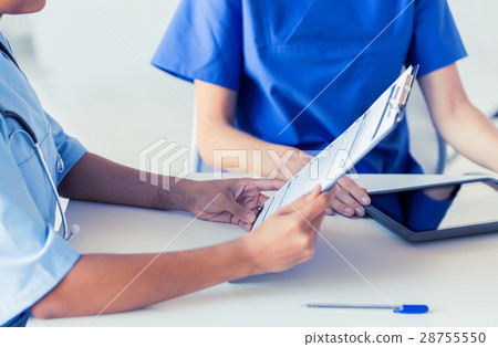 close up of doctor with medical report at hospital close up of doctor with medical report at hospital 28755550