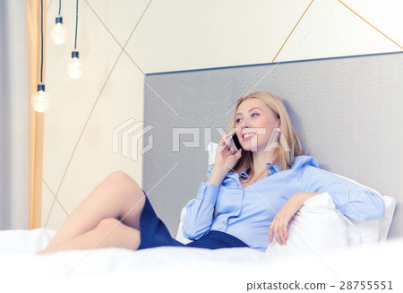 happy businesswoman with smartphone in hotel room 28755551