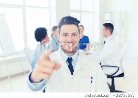 happy doctor over group of medics at hospital happy doctor over group of medics at hospital 28755553