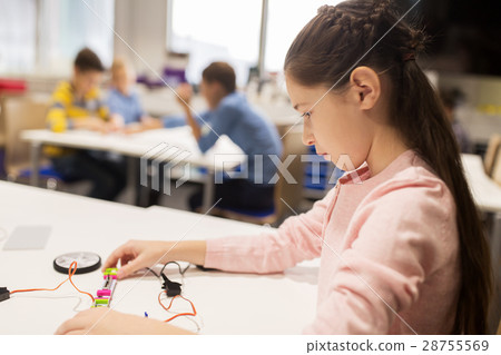 happy girl building robot at robotics school 28755569