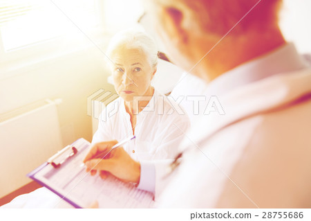 senior woman and doctor with clipboard at hospital senior woman and doctor with clipboard at hospital 28755686