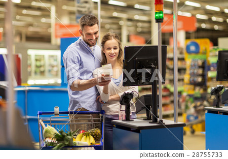 couple buying food at grocery at cash register couple buying food at grocery at cash register 28755733