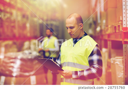 man with clipboard in safety vest at warehouse man with clipboard in safety vest at warehouse 28755760