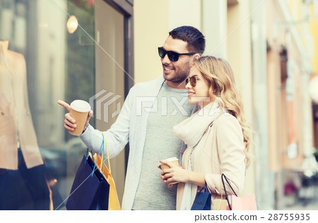 happy couple with shopping bags and coffee in city 28755935