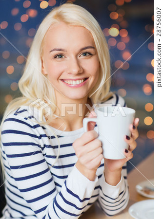 happy young woman with tea or coffee cup 28756007