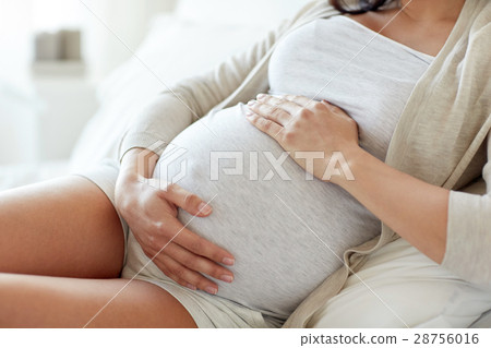 close up of pregnant woman lying in bed at home close up of pregnant woman lying in bed at home 28756016