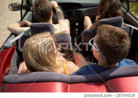 happy friends driving in convertible car at summer happy friends driving in convertible car at summer 28756019
