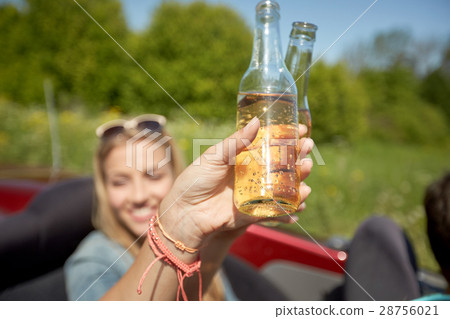 happy young women with drinks in convertible car happy young women with drinks in convertible car 28756021