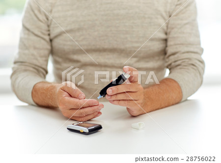 senior man with glucometer checking blood sugar senior man with glucometer checking blood sugar 28756022