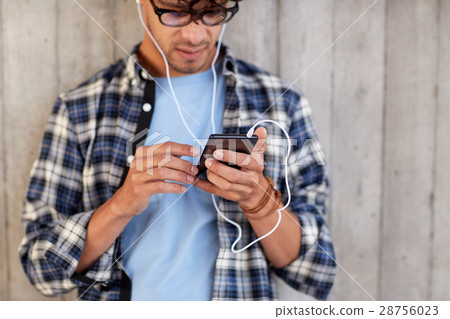 man with earphones and smartphone listening music man with earphones and smartphone listening music 28756023