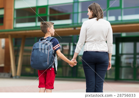 elementary student boy with mother at school yard elementary student boy with mother at school yard 28756033