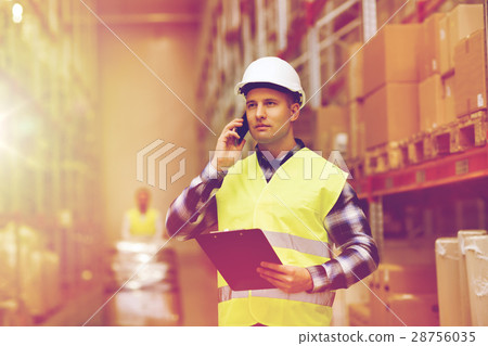 man with clipboard and smartphone at warehouse man with clipboard and smartphone at warehouse 28756035