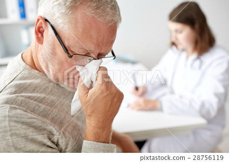 senior man blowing nose and doctor at hospital senior man blowing nose and doctor at hospital 28756119