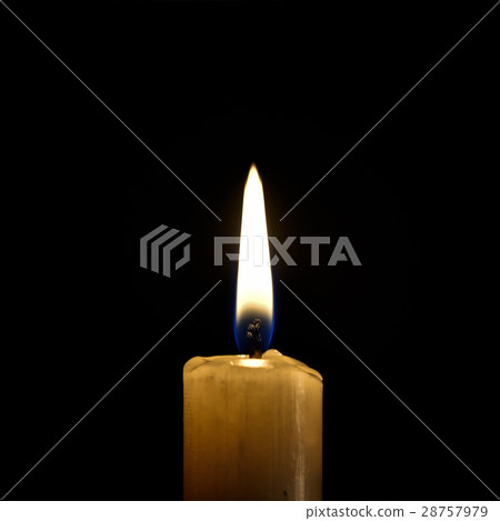 Burning wax candle on a black background Burning wax candle on a black background 28757979