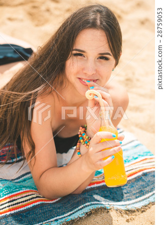 Beautiful young girl drinking water from boutle 28759053