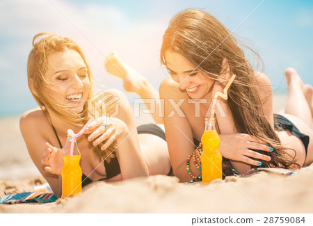 Beautiful young girls drinking water from boutle Beautiful young girls drinking water from boutle 28759084