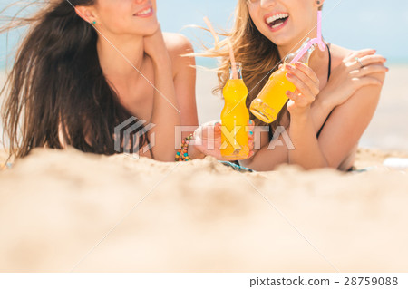 Beautiful young girls drinking water from boutle 28759088