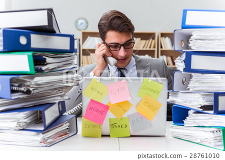 Businessman struggling with multiple priorities Businessman struggling with multiple priorities 28761010