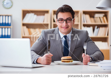 Hungry funny businessman eating junk food sandwich Hungry funny businessman eating junk food sandwich 28761726