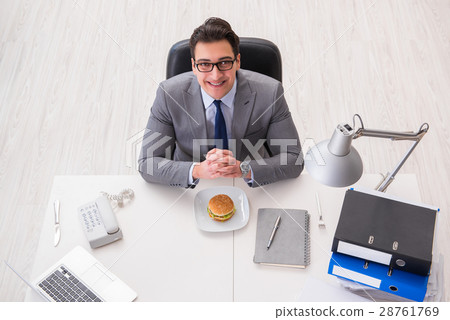 Hungry funny businessman eating junk food sandwich 28761769