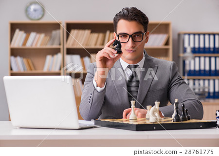 Young businessman playing chess in the office 28761775