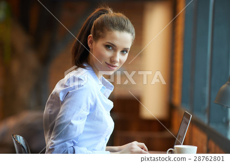 Beautiful, young woman with laptop working in office Beautiful, young woman with laptop working in office 28762801