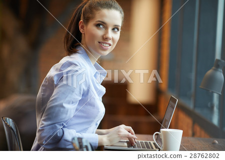 Beautiful, young woman with laptop working in office Beautiful, young woman with laptop working in office 28762802