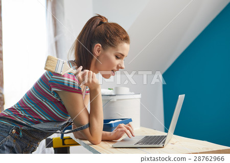 Young woman portrait while painting new apartment  ,looking in l 28762966