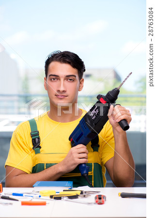 Construction worker sitting at the desk Construction worker sitting at the desk 28763084