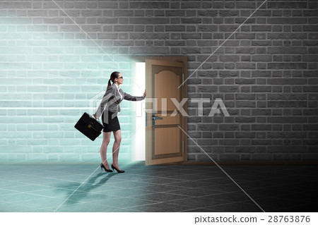 Businesswoman walking towards open door Businesswoman walking towards open door 28763876