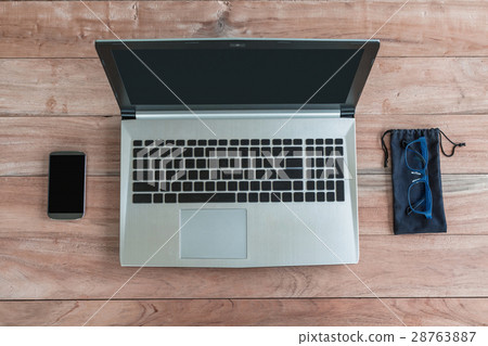 Laptop, glasses blue and smartphone on wood top view Laptop, glasses blue and smartphone on wood top view 28763887
