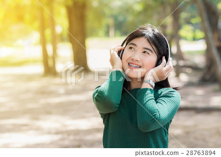 Young beautiful woman girl listening music Young beautiful woman girl listening music 28763894