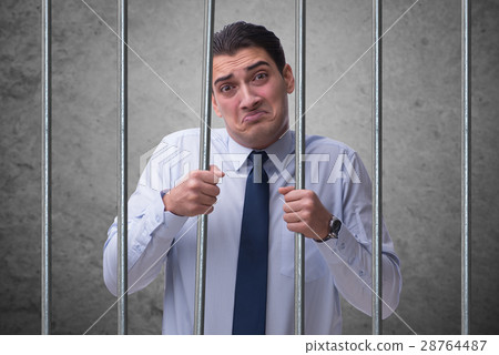 Young businessman behind the bars in prison 28764487