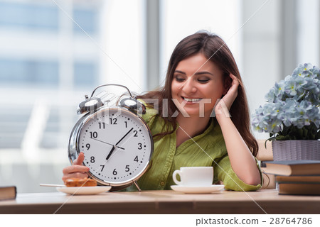 Student with gian alarm clock preparing for exams 28764786