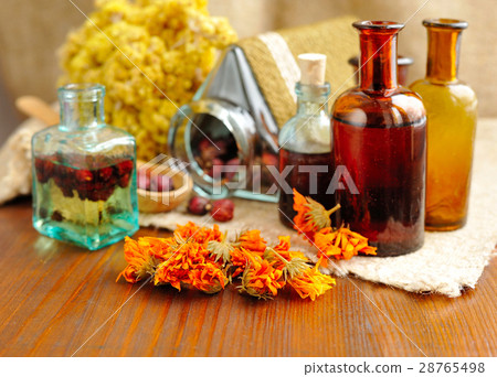 Healing herbs and tinctures in bottles 28765498
