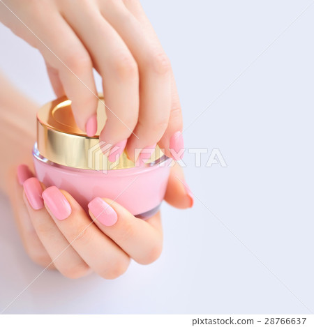 Hands of a woman with pink manicure with cream Hands of a woman with pink manicure with cream 28766637