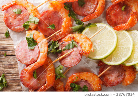 Delicious grilled shrimp with chorizo on skewers Delicious grilled shrimp with chorizo on skewers 28767034